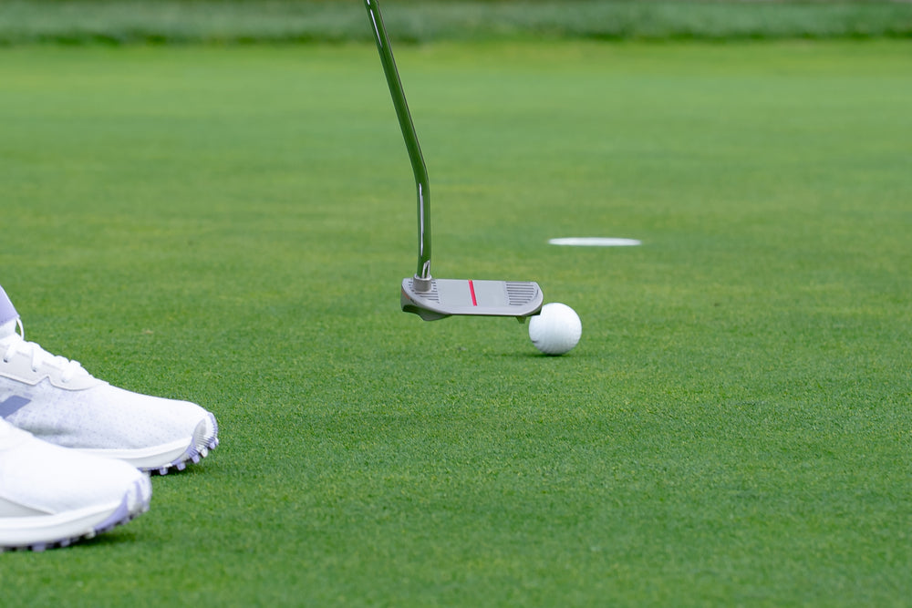 Spoiler OG Putter on green heading toward hole