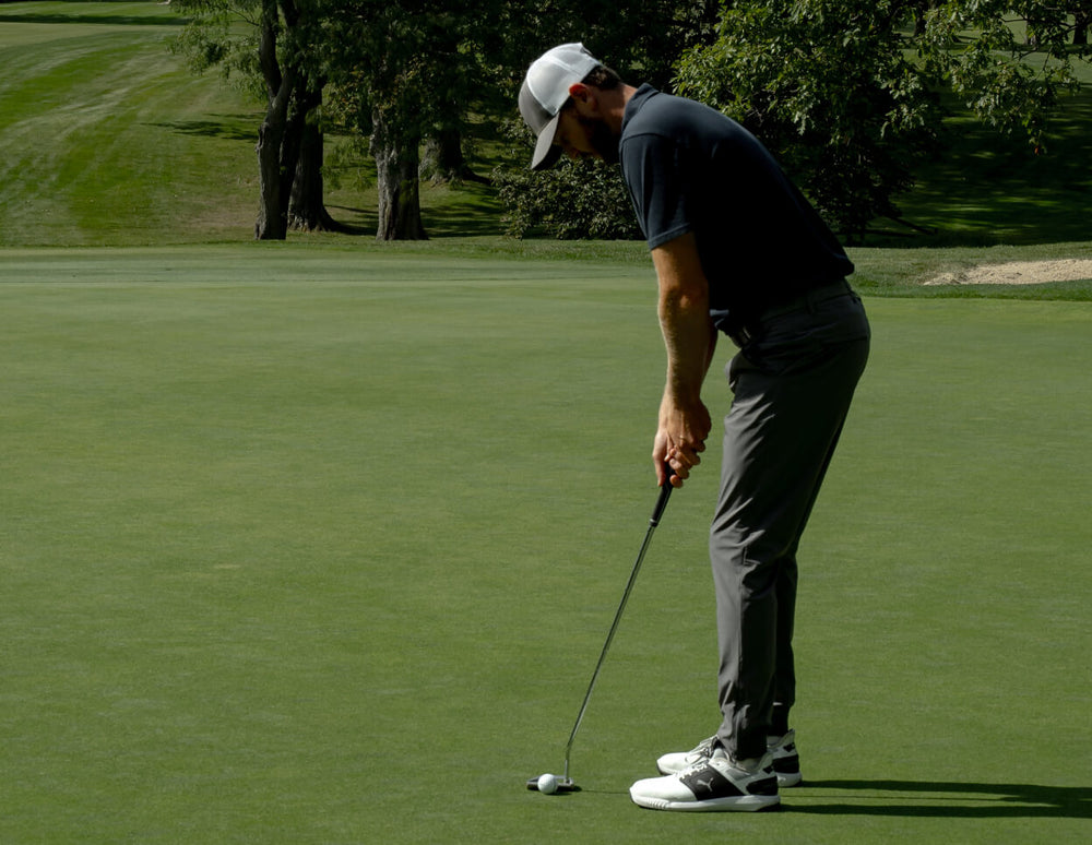 Man on golf course using the Spoiler OG putter