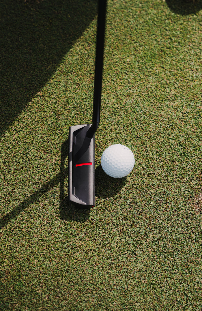 A golfer watching the roll of a putt